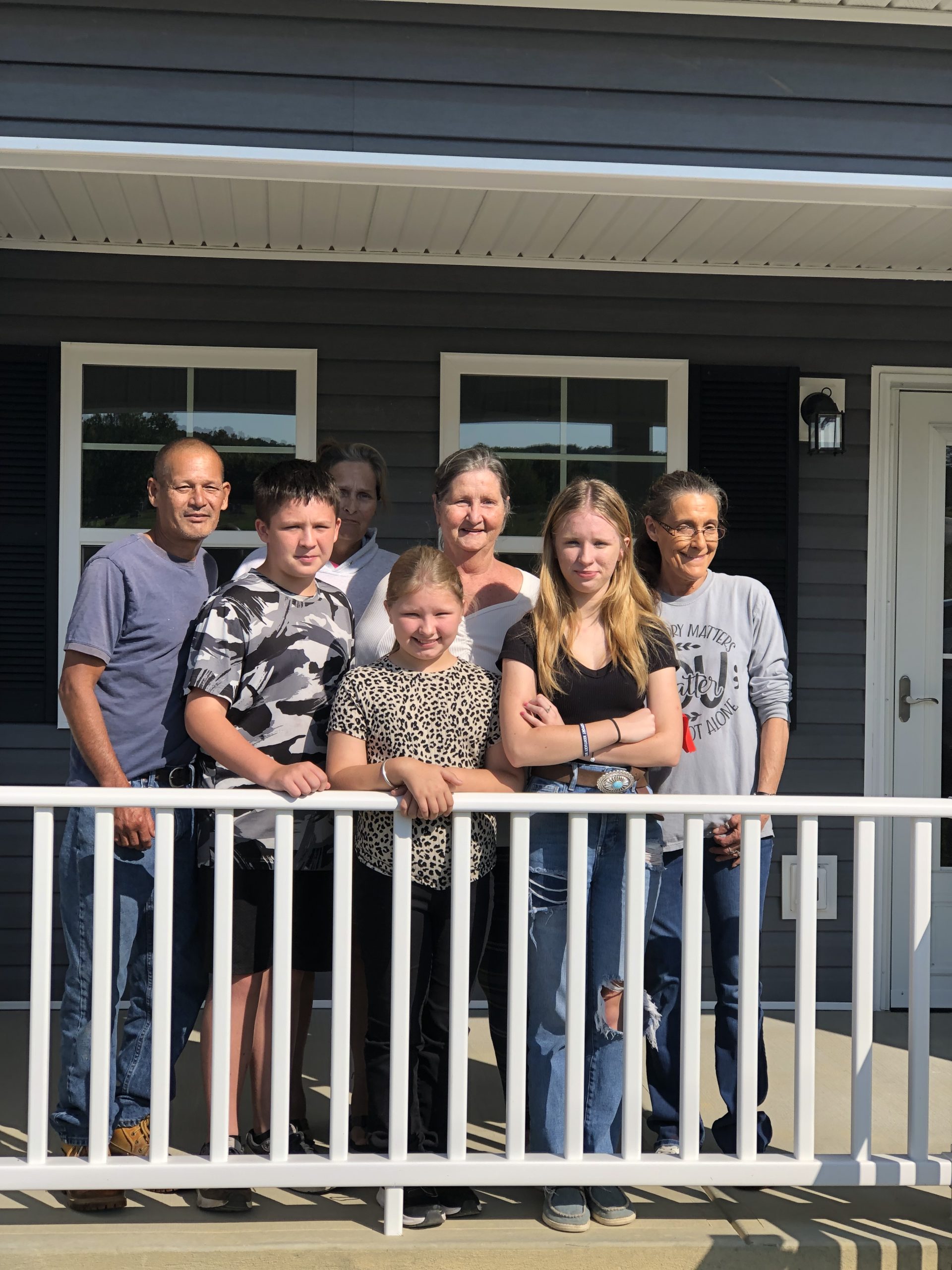 Elda Bowen and her family on the front porch of their new home in Bath County.