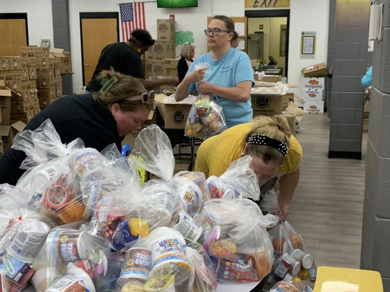 Fleming County employees fill food packages for kids to enjoy over the summer last year.