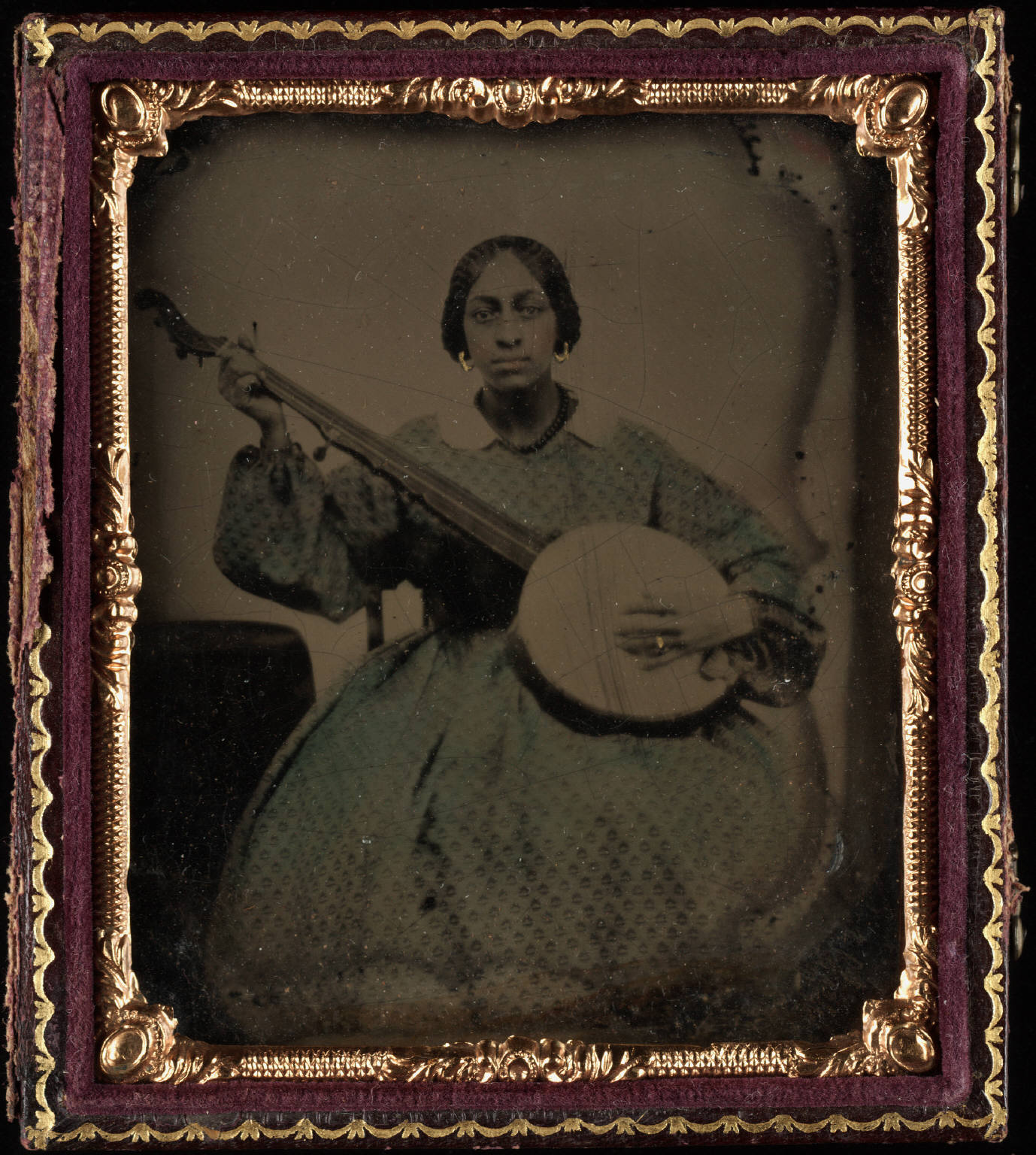 Portrait_of_a_young_black_woman__seated__holding_nine_string_banjo_medium_medium.jpg Portrait of a young black woman, seated, holding nine string banjo